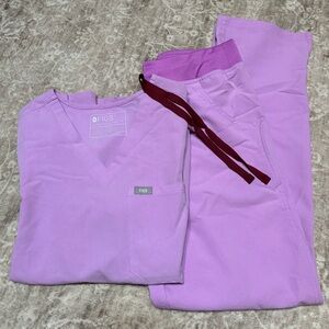 FIGS scrubs. One top and two pairs of pants of the same color.